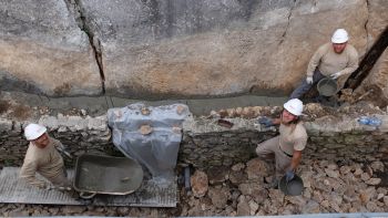 Arthur, Nicolas et Hafedh, chef de chantier de l'entreprise SELE recouvrent le ferraillage de la longrine