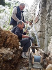 Daniel et Alain posent le cadre sur le coffrage dans le caniveau 